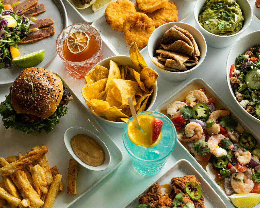 A table filled with assorted dishes in different colours and textures, creating a visually rich dining spread.