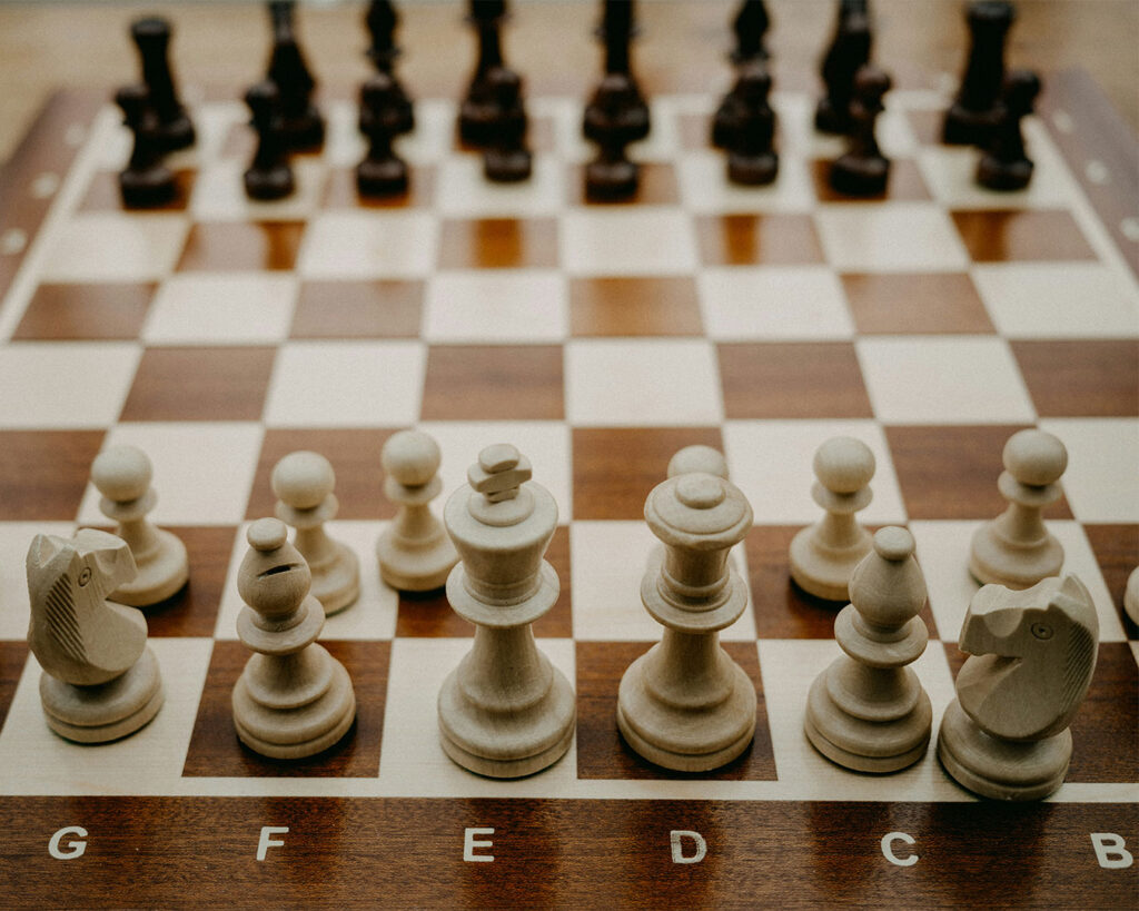 A chessboard with arranged pieces, representing strategic planning, critical thinking, and careful decision-making before the next move.