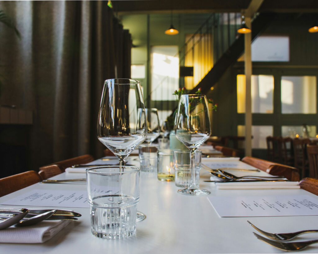 A neatly arranged restaurant table setup, showing readiness for service and attention to dining presentation.
